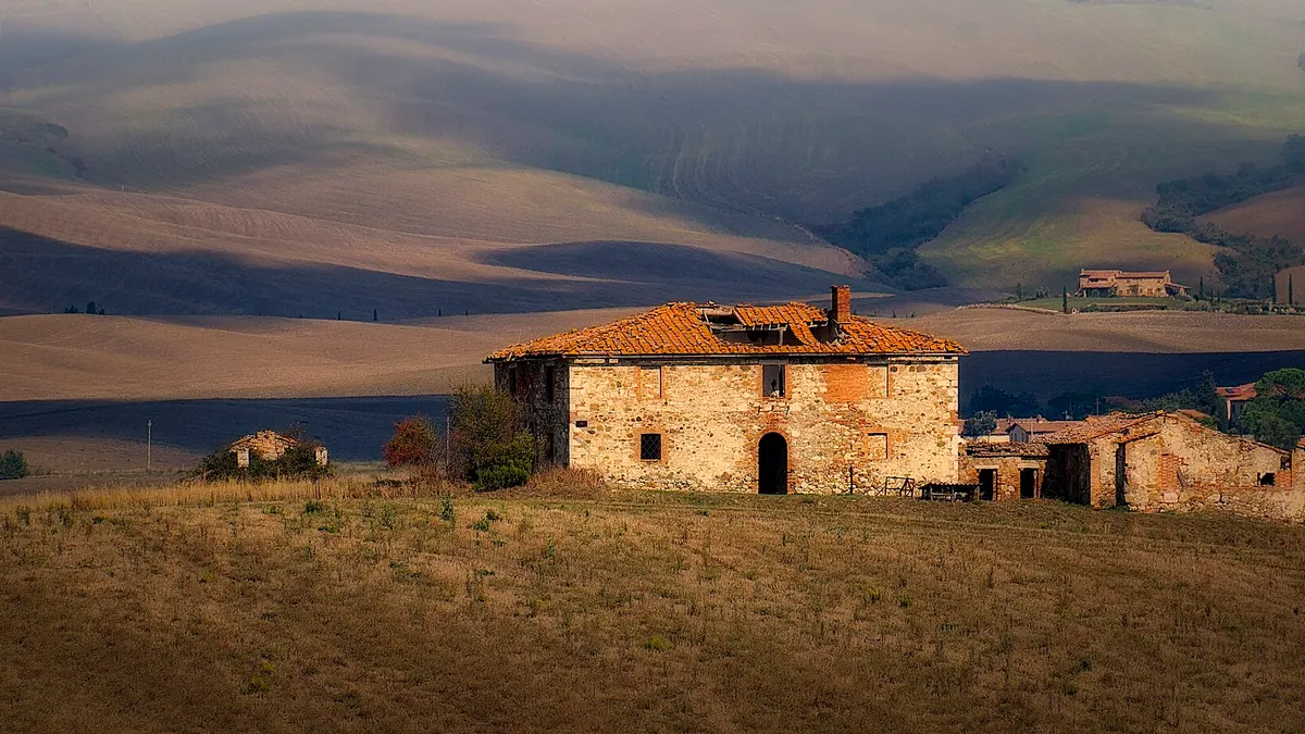 A stone farmhouse on a hillside in the Val d'Orcia, Tuscany